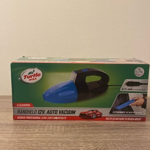 New never opened hand held auto vacuum